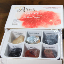 Load image into Gallery viewer, Aries Horoscope Crystals from Rock Paradise. Photo shows a white box that has a pink colored ink blot with the Aries constellation and illustrations of gemstones. The box reads "Aries nature made crystals to complement your zodiac sign. The Ram. March 21-April 19. Contents: Citrine, Blue Onyx, Black Obsidian, Red Jasper, Carnelian, Hematite."