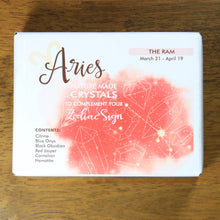 Load image into Gallery viewer, Aries Horoscope Crystals from Rock Paradise. Photo shows a white box that has a pink colored ink blot with the Aries constellation and illustrations of gemstones. The box reads "Aries nature made crystals to complement your zodiac sign. The Ram. March 21-April 19. Contents: Citrine, Blue Onyx, Black Obsidian, Red Jasper, Carnelian, Hematite."