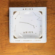 Load image into Gallery viewer, Aries Zodiac Ring Dish from Lucky Feather. Light blue colored ring dish with gold print. Ring dish says Aries and has an illustration of the Aries constellation.