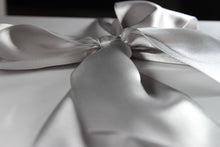 Load image into Gallery viewer, Close up side view of a silver satin bow on a white box