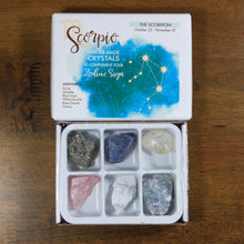 Load image into Gallery viewer, Scorpio Horoscope Crystals from Rock Paradise. Photo shows a white box that has a blue ink blot with the Scorpio constellation and illustrations of gemstones. The box reads "Scorpio nature made crystals to complement your zodiac sign." Box has 6 crystals in it.
