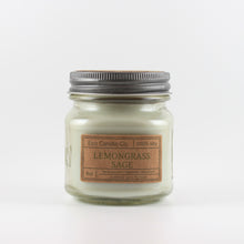 Load image into Gallery viewer, Mason Jar candle: an 8 oz mason jar with a metal cap, filled with sage green wax, with a kraft paper label on the front that reads "Lemongrass Sage"
