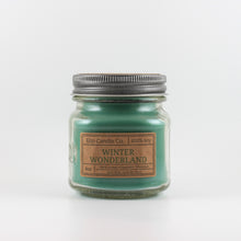 Load image into Gallery viewer, Mason Jar candle: an 8 oz mason jar with a metal cap, filled with green wax, with a kraft paper label on the front that reads "Winter Wonderland"