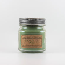 Load image into Gallery viewer, Mason Jar candle: an 8 oz mason jar with a metal cap, filled with green wax, with a kraft paper label on the front that reads "Eucalyptus Sage"