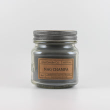 Load image into Gallery viewer, Mason Jar candle: an 8 oz mason jar with a metal cap, filled with grey wax, with a kraft paper label on the front that reads "Nag Champa"