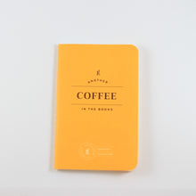 Load image into Gallery viewer, Small yellow passport journal from Letterfolk with gold print that says "Another coffee in the books"