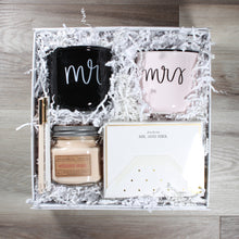 Load image into Gallery viewer, overhead view of "Mr & Mrs" wedding gift box with candle, two mugs, note cards, and felt pens in a white box with white crinkle paper