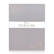 Load image into Gallery viewer, A purple-grey journal with gold embossed illustrations of crystal gemstones. A band around the journal says "You're a gem, jot down your sparkly thoughts."