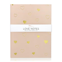 Load image into Gallery viewer, A light pink journal with hearts in solid gold and gold line art. A band around the journal says "Love notes, write your heart out."