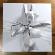 Load image into Gallery viewer, overhead view of white gift box with silver satin ribbon tied in a bow