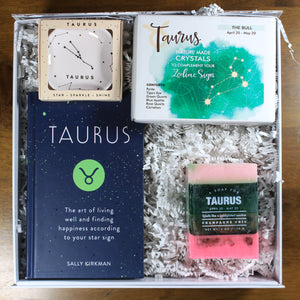 This photo shows the Doromania "What's Your SIgn? - Taurus" zodiac gift box with a Taurus ring dish, Taurus Book, Taurus crystals, and Taurus soap all in a white box with white crinkle paper