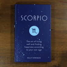 Load image into Gallery viewer, A dark blue book titled Scorpio: The art of living well and finding happiness according to your star sign. The book is by Sally Kirkman. The cover has the title, author, and the Scorpio zodiac symbol in a light blue circle.