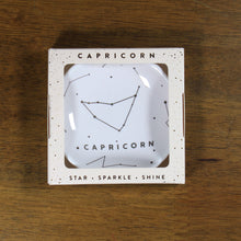 Load image into Gallery viewer, Capricorn Zodiac Ring Dish from Lucky Feather. Cream colored ring dish with gold print. Ring dish says Capricorn and has an illustration of the Capricorn constellation.