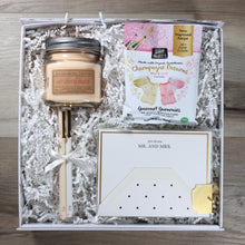 Load image into Gallery viewer, overhead view of dearly beloved wedding gift box with candle, gummies, note cards, and felt pens in a white box with white crinkle paper