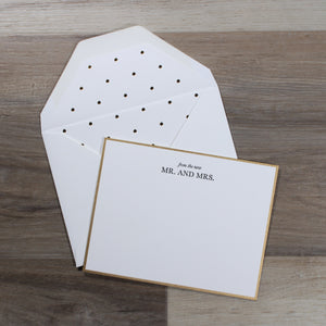 overhead view of single notecard that says "from the new mr. and mrs." with a polka dot lined envelope, from dearly beloved wedding gift box
