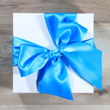 Load image into Gallery viewer, An overhead view of a white magnetic square gift box with a teal satin ribbon tied in a bow