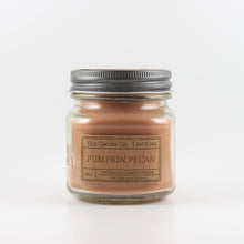 Load image into Gallery viewer, Mason Jar candle: an 8 oz mason jar with a metal cap, filled with brown wax, with a kraft paper label on the front that reads &quot;Pumpkin Pecan&quot;