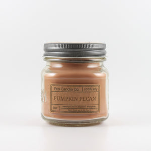 Mason Jar candle: an 8 oz mason jar with a metal cap, filled with brown wax, with a kraft paper label on the front that reads "Pumpkin Pecan"