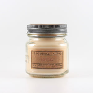 Mason Jar candle: an 8 oz mason jar with a metal cap, filled with off white wax, with a kraft paper label on the front that reads "Lovely"