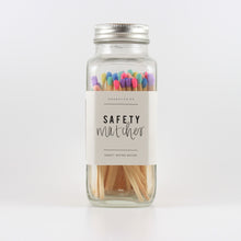Load image into Gallery viewer, A glass jar with a metal lid, filled with match sticks that have multi colored tips, and a label on the bottle that says &quot;safety matches&quot;