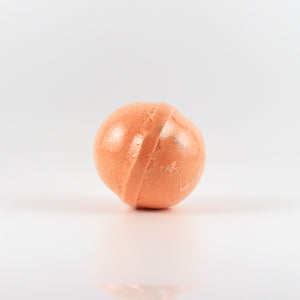 A photo of an orange pumpkin spice fizzy bath bomb from the pumpkin spice everything gift box