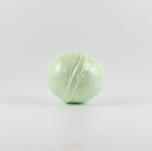 Load image into Gallery viewer, A light green colored, oval shaped bath bomb on a white background