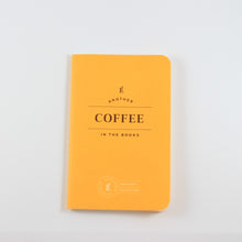 Load image into Gallery viewer, Small yellow passport journal from Letterfolk with gold print that says &quot;Another coffee in the books&quot;