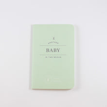 Load image into Gallery viewer, Small light mint green passport journal from Letterfolk with silver print that says &quot;Another Baby in the books&quot;