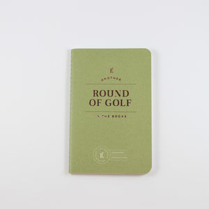 Small green passport journal from Letterfolk with gold print that reads "Another Round of Golf in the Books"