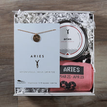 Load image into Gallery viewer, small aries gift box with an aries disc necklace, an aries candle, and aries socks. These gifts are in a white gift box with white crinkle paper.
