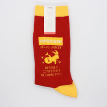 Load image into Gallery viewer, Capricorn socks by HOTSOX. The socks are red with yellow accents. This photo shows the left sock, which says &quot;Capricorn December 22-January19. Refined, competent, resourceful.&quot;