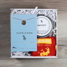 Load image into Gallery viewer, small Capricorn gift box with a Capricorn disc necklace, a Capricorn candle, and Capricorn socks. These gifts are in a white gift box with white crinkle paper.