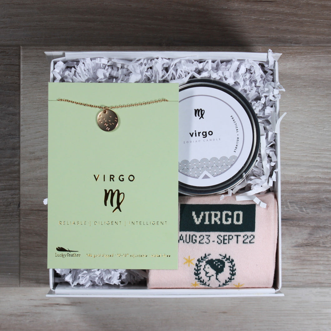 small Virgo gift box from Doromania. Box includes a Virgo disc necklace, a Virgo candle, and Virgo socks. These gifts are packaged in a white gift box with white crinkle paper.