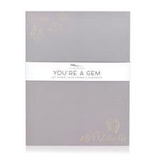 Load image into Gallery viewer, A purple-grey journal with gold embossed illustrations of crystal gemstones. A band around the journal says &quot;You&#39;re a gem, jot down your sparkly thoughts.&quot;